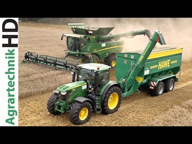 Tractors of John Deere New Holland with the HAWE grain cart | Claas combines | Farming