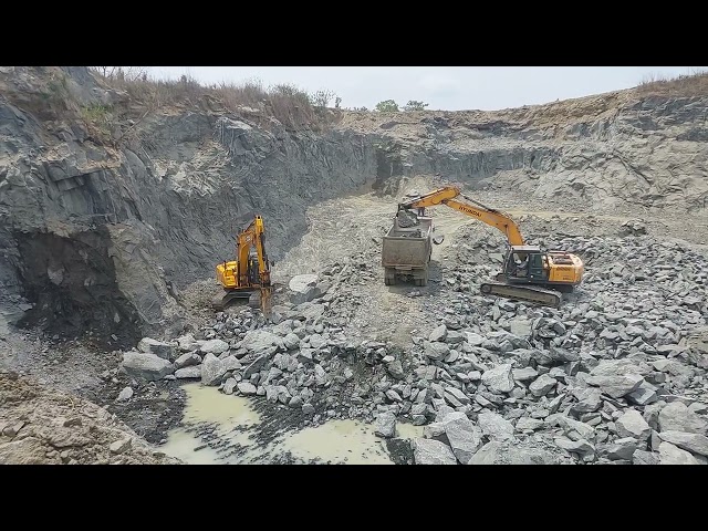 Heavy Machinery at Work: JCB 205 Excavator vs Hyundai 220 Loader in Stone Quarry!