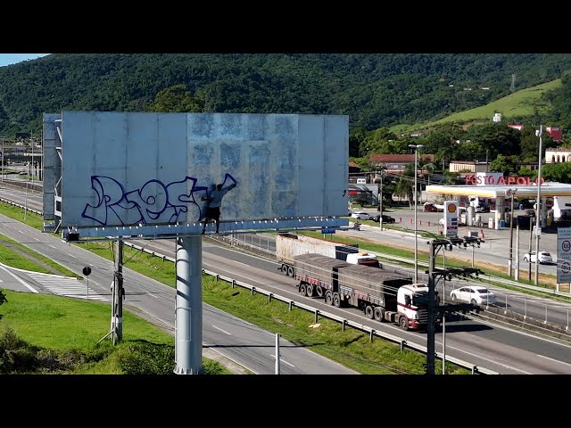 Daytime Graffiti on Billboard with Drone Footage