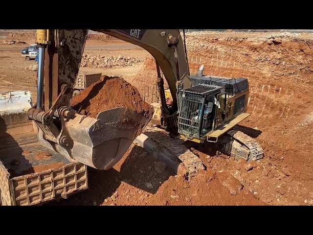 Caterpillar 365C Excavator Loading Trucks With Three Passes