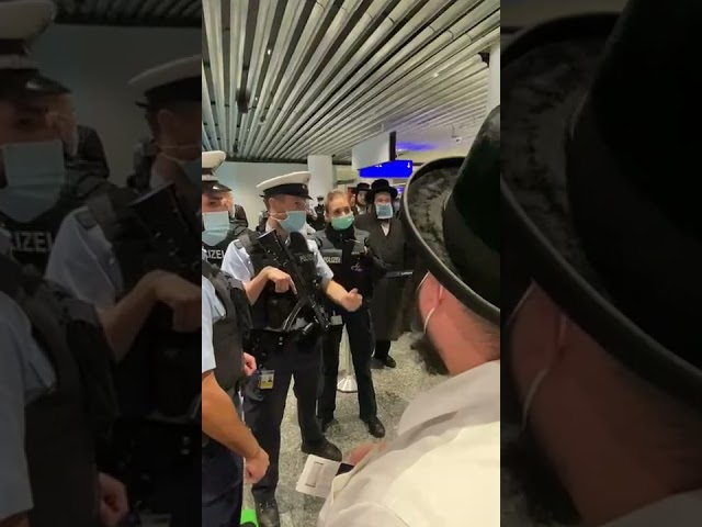German Policeman reacts to being called a Nazi at the gate of Lufthansa 1334