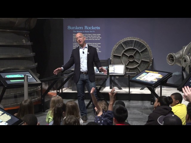 Jeff Bezos speaks with students at the opening of the Apollo exhibit at The Museum of Flight