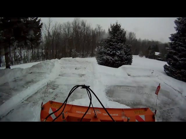 Bobcat S185 plowing snow on long concrete driveway