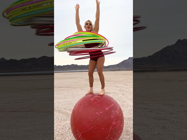Most hula hoops spun simultaneously while balancing on a giant rolling globe - 28 by Grace Good 🇺🇸