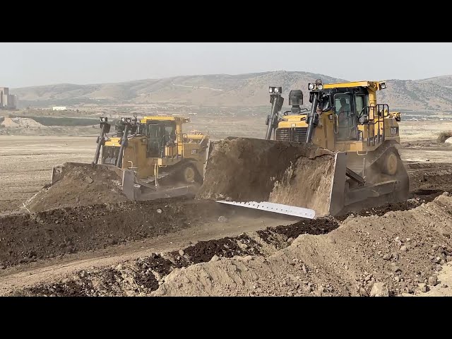 Caterpillar D9T And Komatsu D275 Bulldozers Team Levelling A Huge Old Mining Area