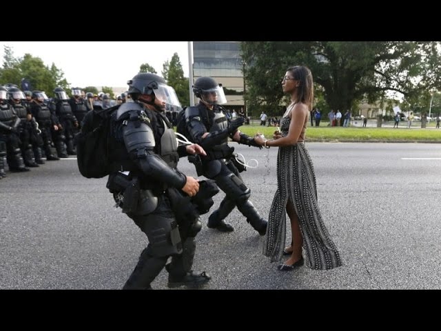 See Powerful Image of Woman Wearing Dress While Facing Police During Protest