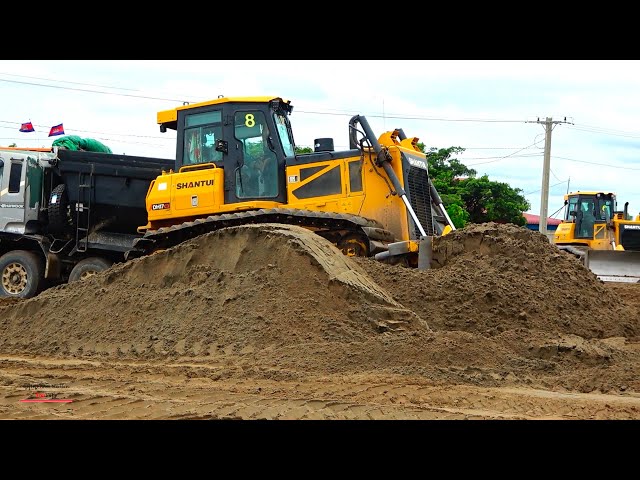 Extremely​​ shantui bulldozer operating with truck dumper spread stuck sandy