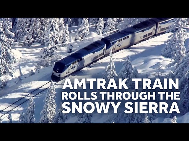 Amtrak Train Crawls through the Snowy Sierra Mountains in California