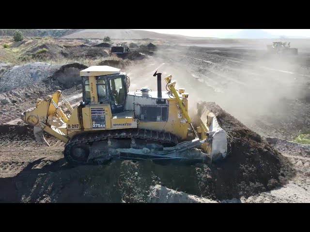 Two Caterpillar D9T And Komatsu D275AX Bulldozers Working On Huge Mining Area