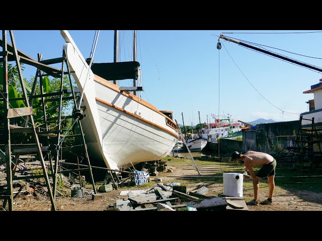 Installing a restored muffler to the exhaust system of our once wrecked boat — Sailing Yabá 193