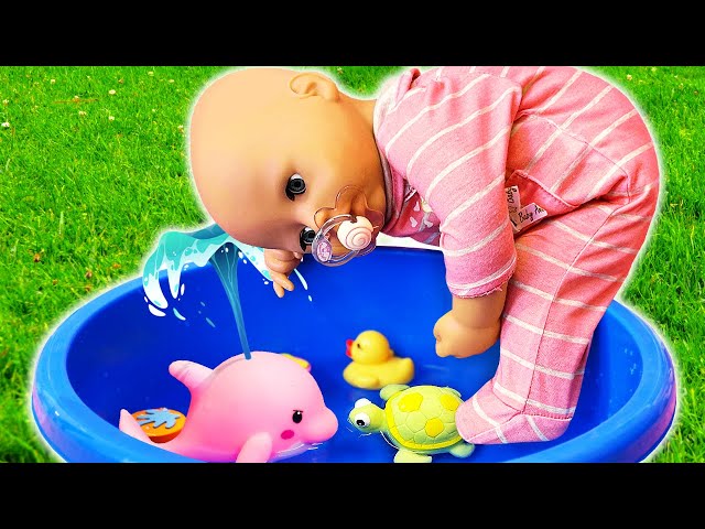 Baby Annabell doll plays with water at the swimming pool. Pretend play babysitter for baby dolls.