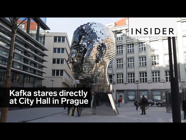 A sculpture of Franz Kafka's head faces City Hall in Prague