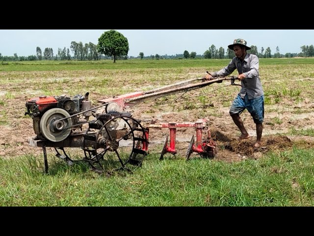 Small Old Kubota Tractor Plowing Muddy Field