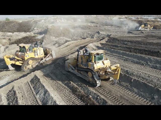 Aerial View Of Four Caterpillar D9T & Komatsu D275AX Bulldozers Team -Levelling Huge Mining Site