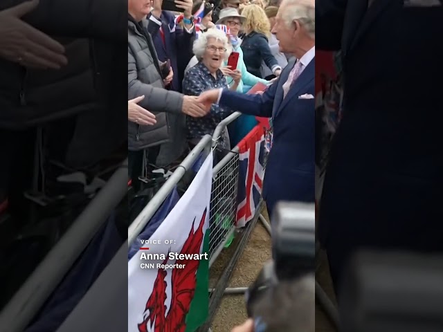Woman kisses King Charles' hand as he greets crowds
