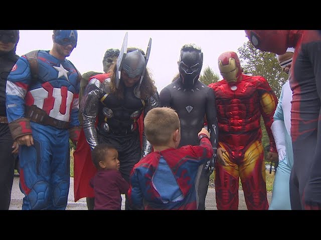 High school football players surprise birthday boy dressed as superheroes