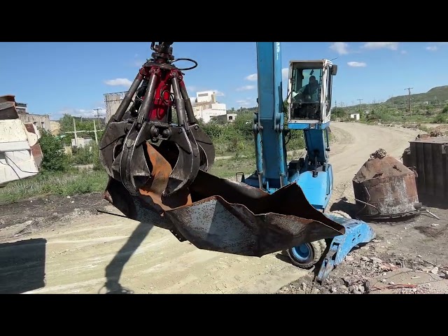 Terex Fuchs MHL350 Loads Scrap Metal In Caterpillar 777C Dumper-Sotiriadis/Labrianidis Recycle Works