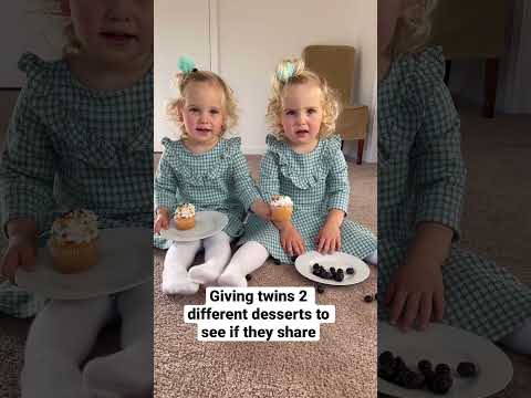 Twin babies share sweets