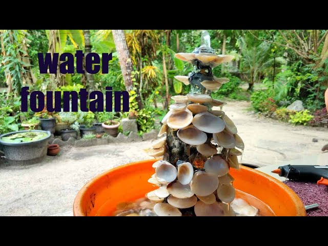 Amazing water fountain with glass bottle and clam