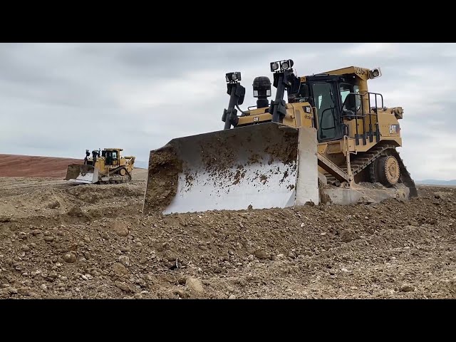 Two Caterpillar D9 Bulldozers Ripping And Pushing Soil