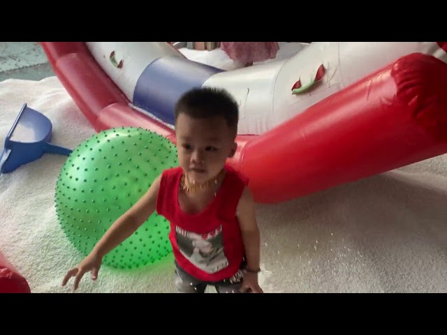 Kids at indoor playground play center with toys and house snow