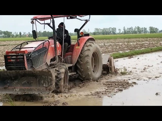 Kubota M6040SU Tractor Machine Tilling Muddy Field