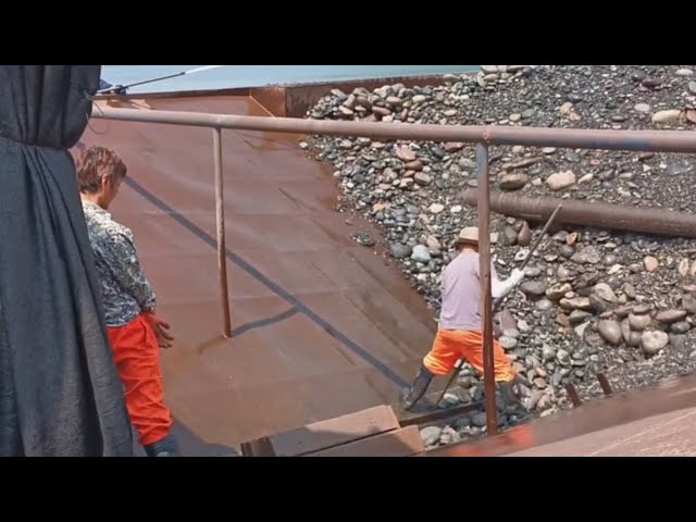 Barge unloading large cobblestones and iron ore - Relaxing video