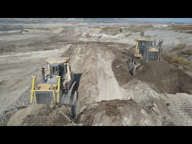Caterpillar D9T And Komatsu D275 Bulldozers Pushing Soil On Huge Mining Area