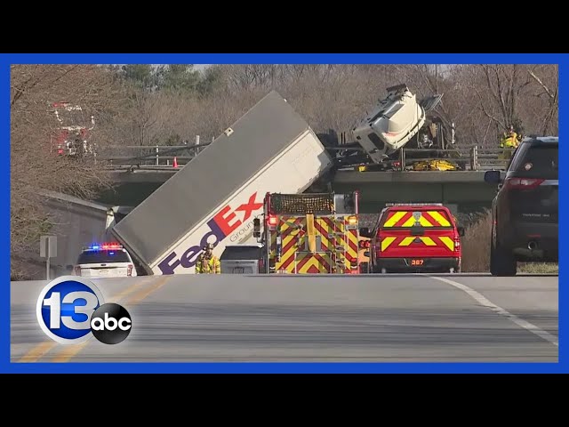 Tractor-trailer dangles off bridge following crash on highway