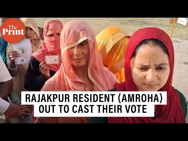 Residents froom Rajakpur (Amroha) in queues to cast their vote in the second phase of LS polls