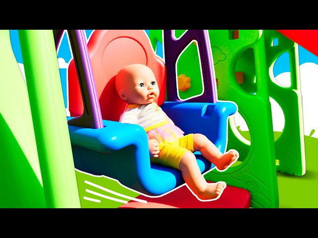 Baby Annabell doll plays with toys. Baby Born doll on a playground for kids. Pacifier for baby dolls