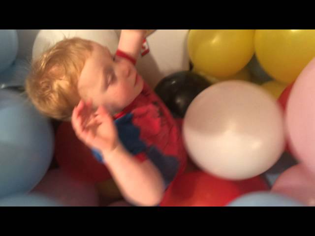 Kid buried in balloons