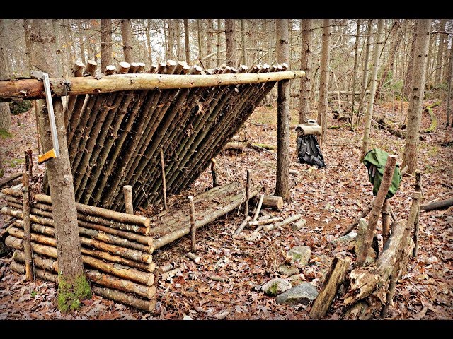 Solo Bushcraft Camp. Natural Shelter, Wool Blanket, Raised Bed, Long Fire.