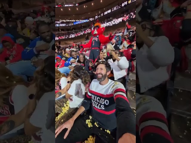 Benny the Bull showers fans with popcorn at Chicago Bulls game